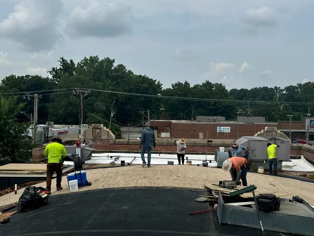 Crew working on a commercial roof in University City