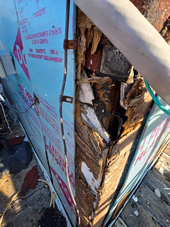 Close-up of deteriorated wood discovered after the exterior covering was removed.