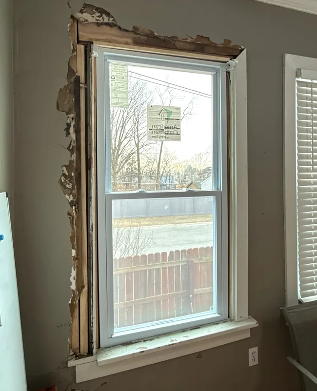 Window during interior restoration with surrounding wall finish removed.